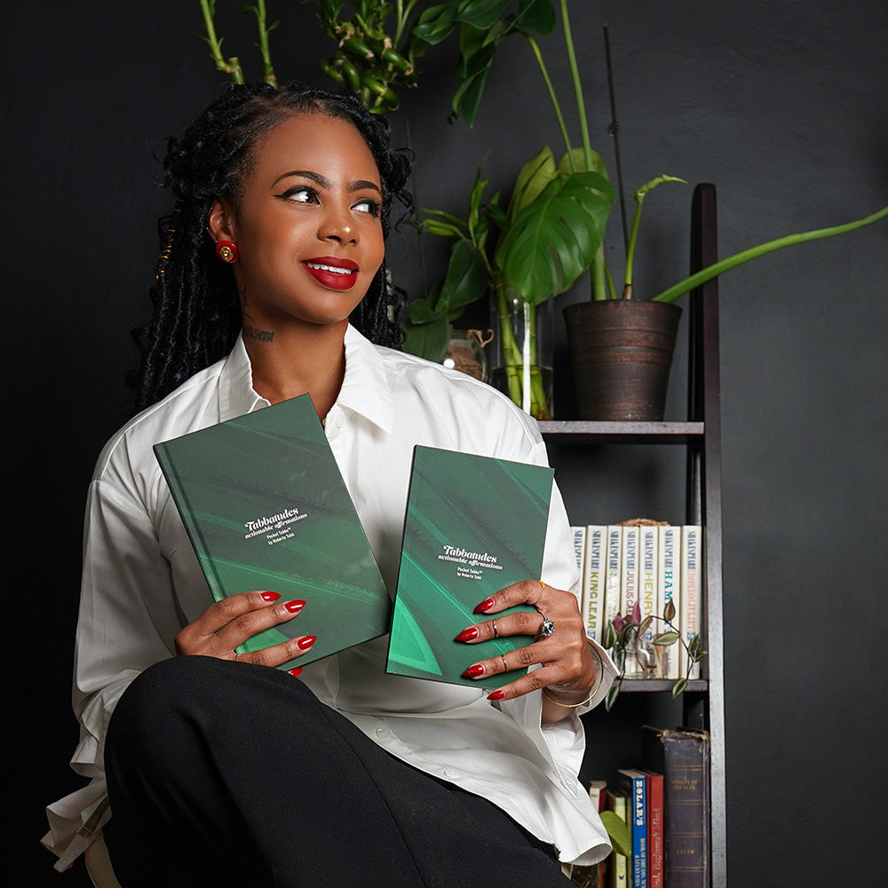 Roberta Tabb holding Tabbatudes Affirmation book for daily motivation and self-care